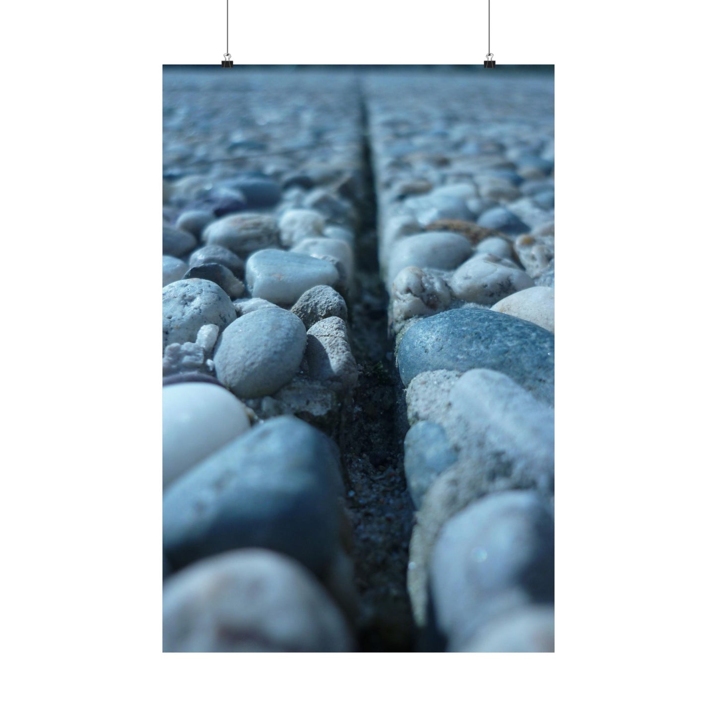 Close-up of pebbles with a crack running through them on a white background