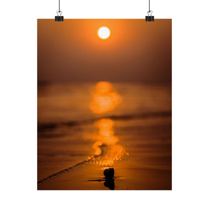 Sunset over water with a person standing in the foreground