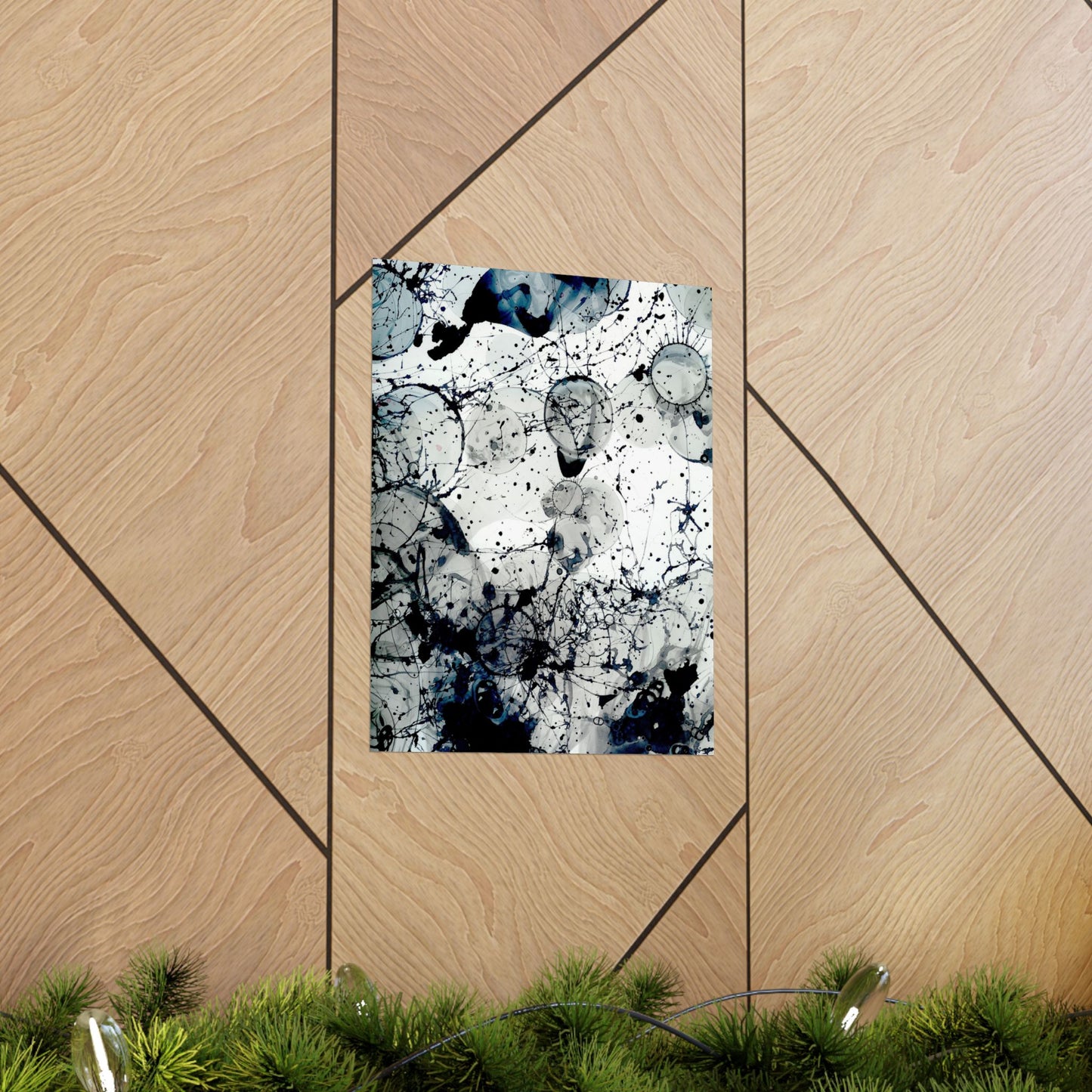 Abstract art print on a wooden panel with greenery at the bottom