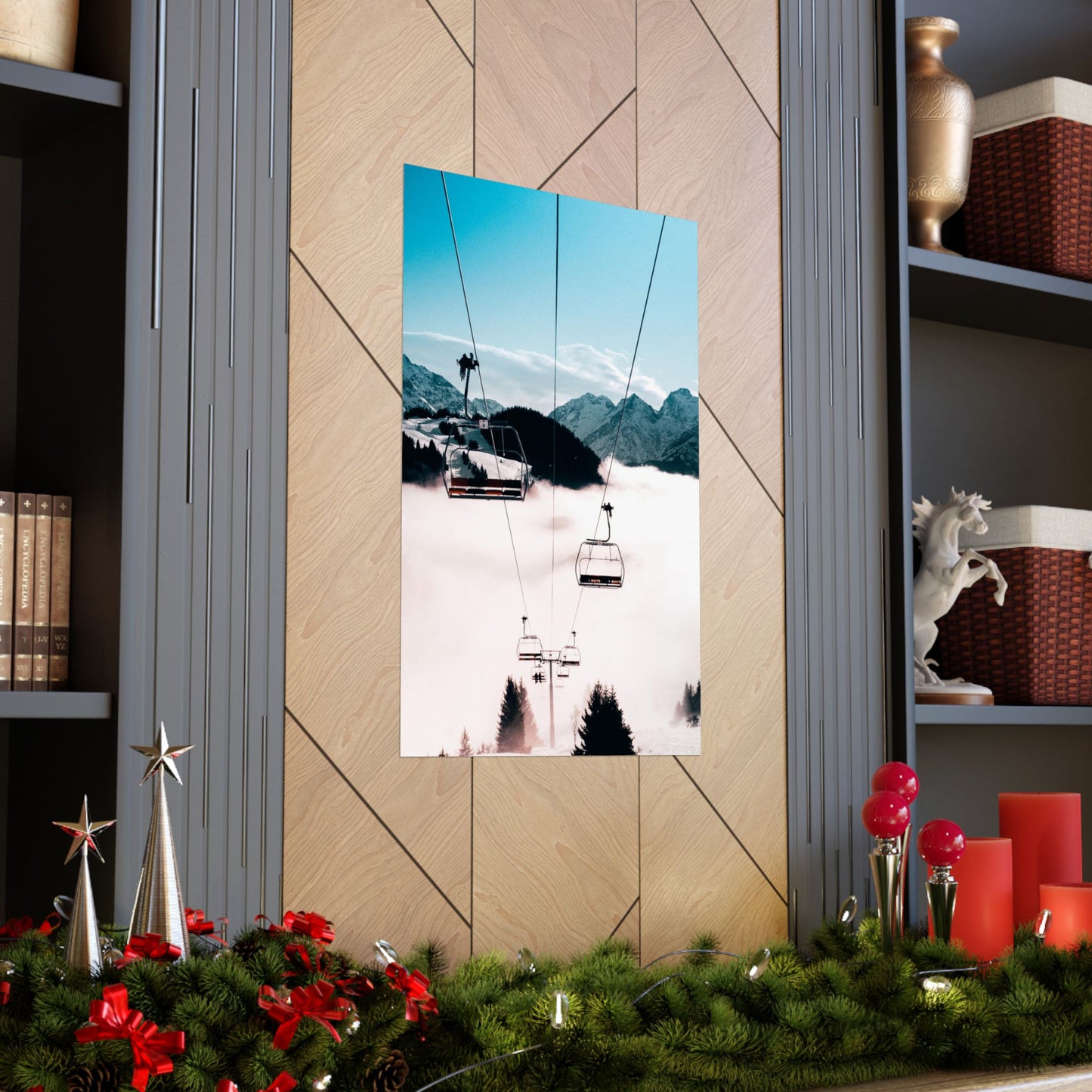 Decorative wall art of a mountain scene with ski lifts on a wooden wall, surrounded by festive decorations.