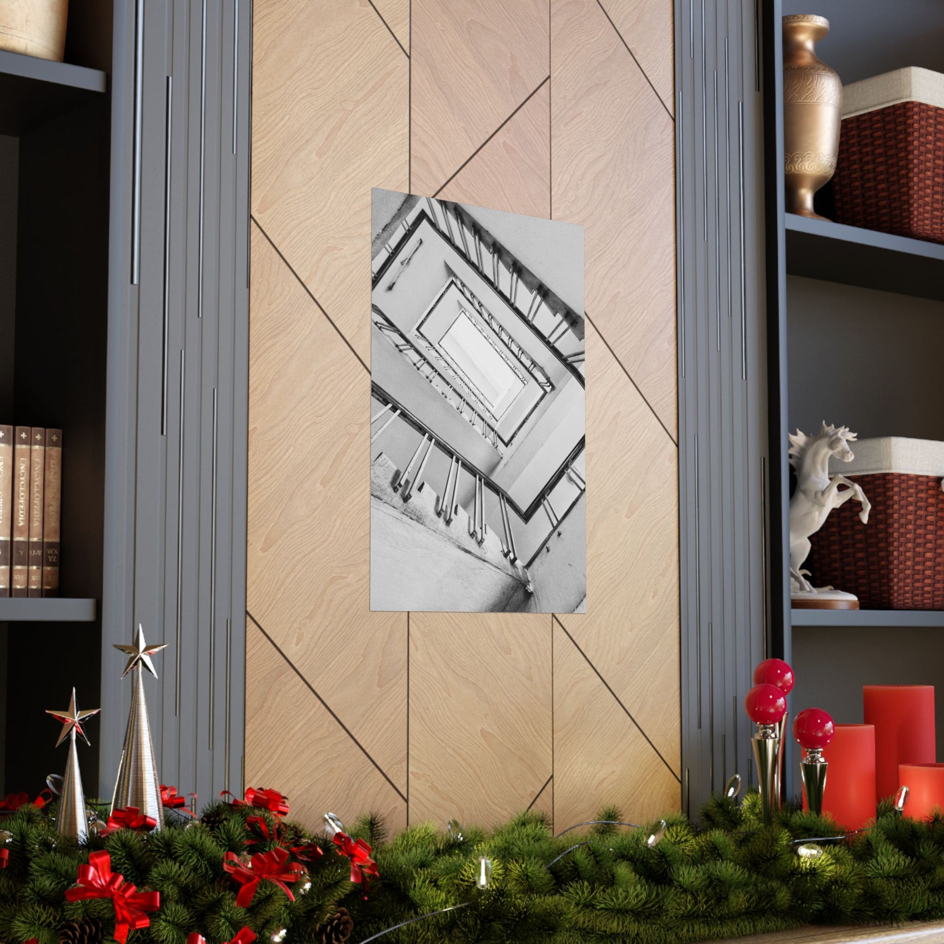 Decorative wall art on a wooden panel with Christmas decorations below.