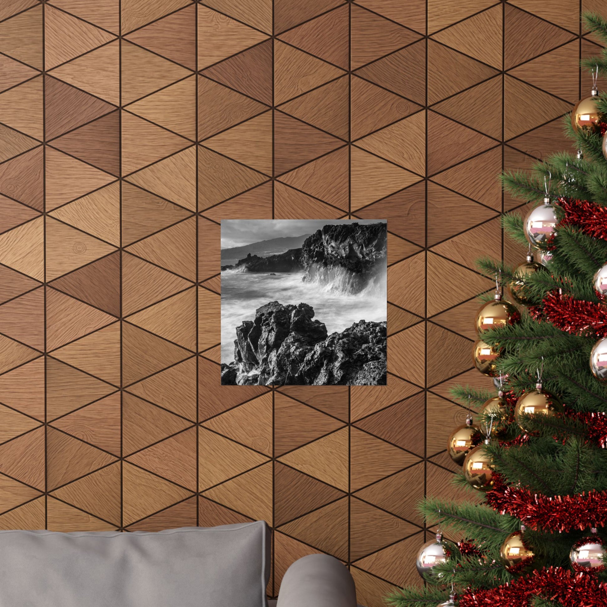 Wooden wall with geometric pattern, framed black and white photo, and decorated Christmas tree.