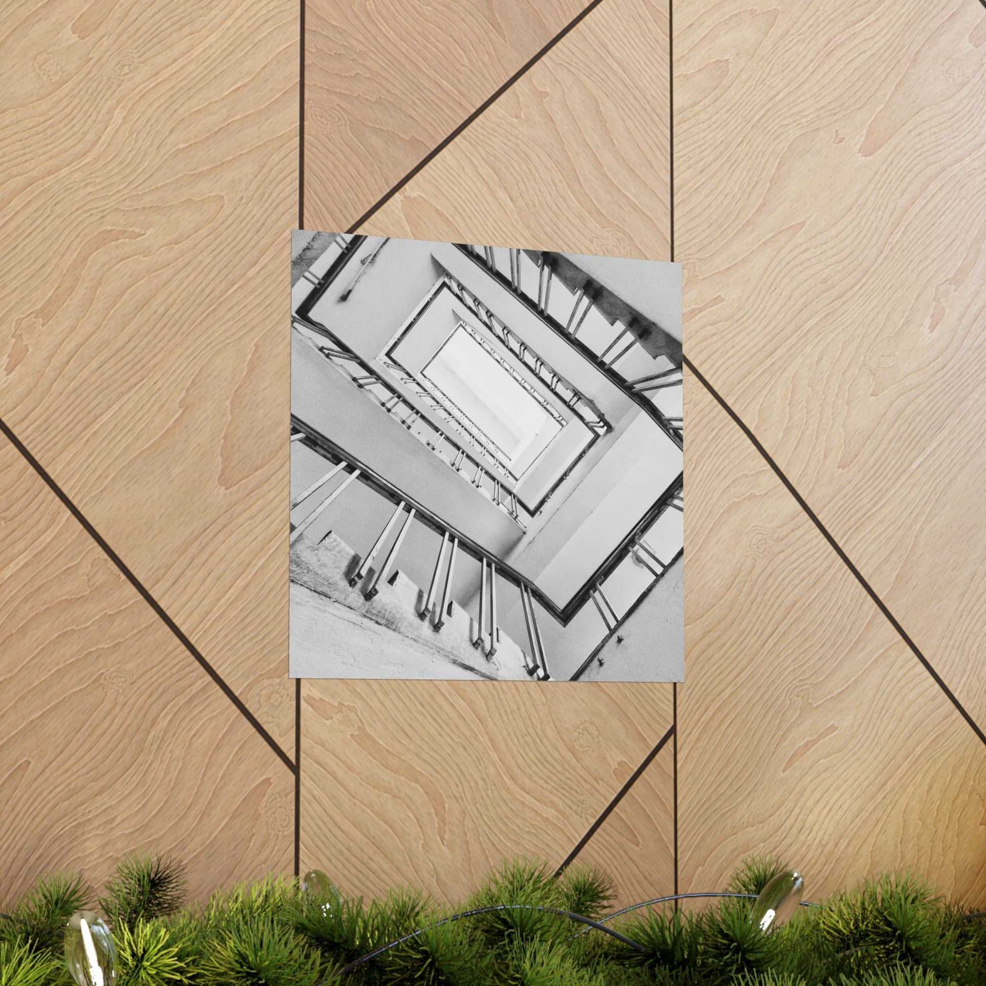 Poster of a staircase on a wooden floor with green plants at the bottom.