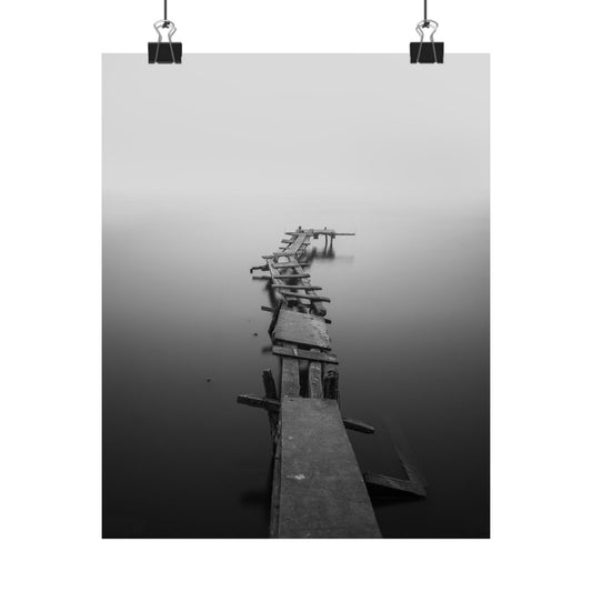 Wooden pier extending into a foggy body of water