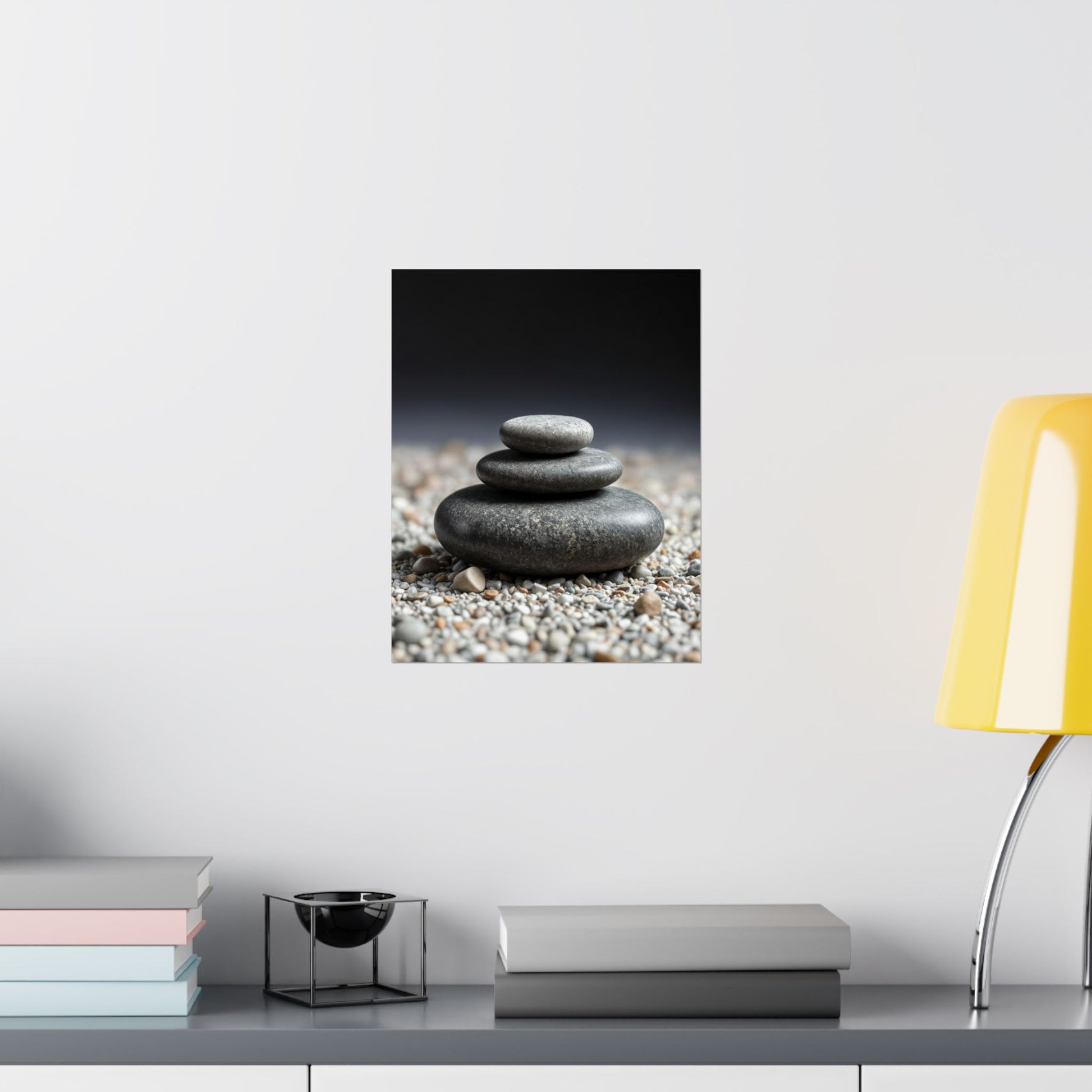 Stylized image of stacked stones on a pebble bed with a yellow lamp and books on a shelf.