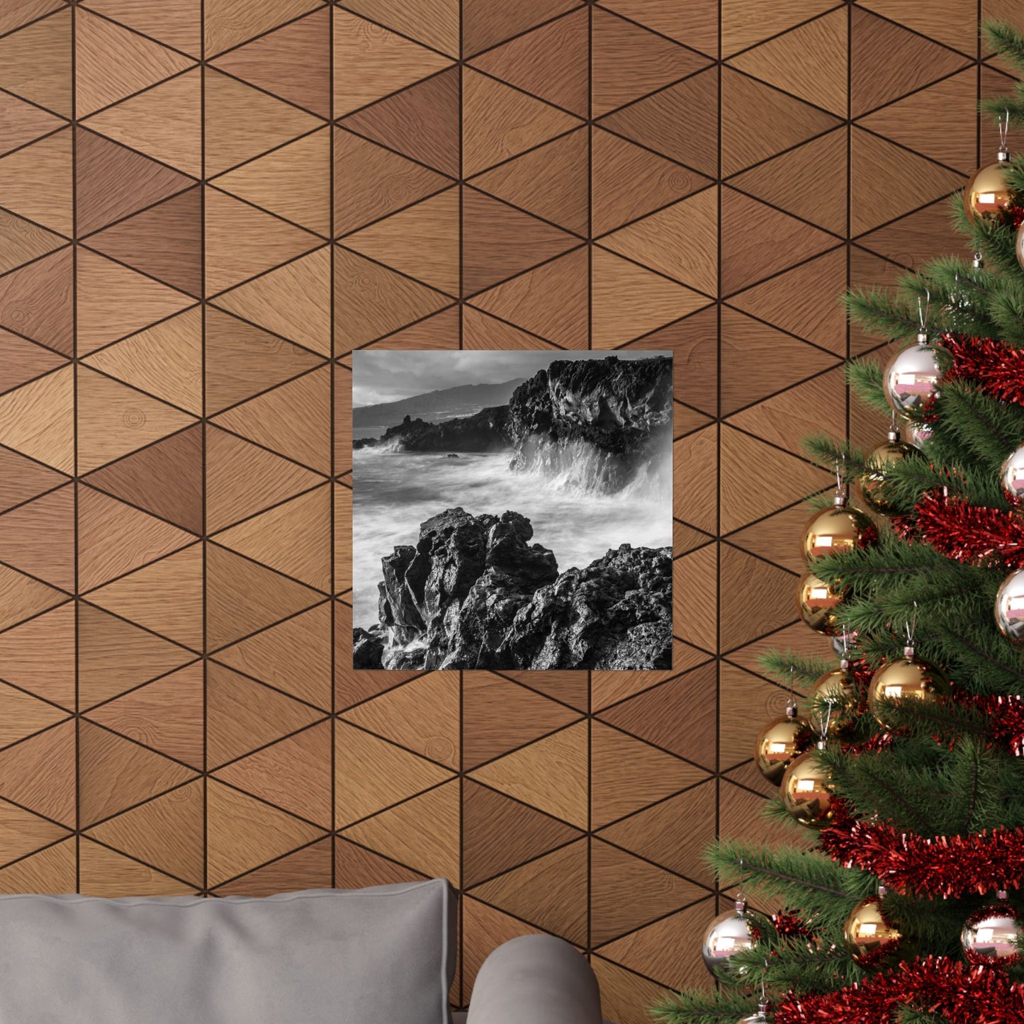 Wooden wall with geometric pattern, framed picture of rocky landscape, and decorated Christmas tree.