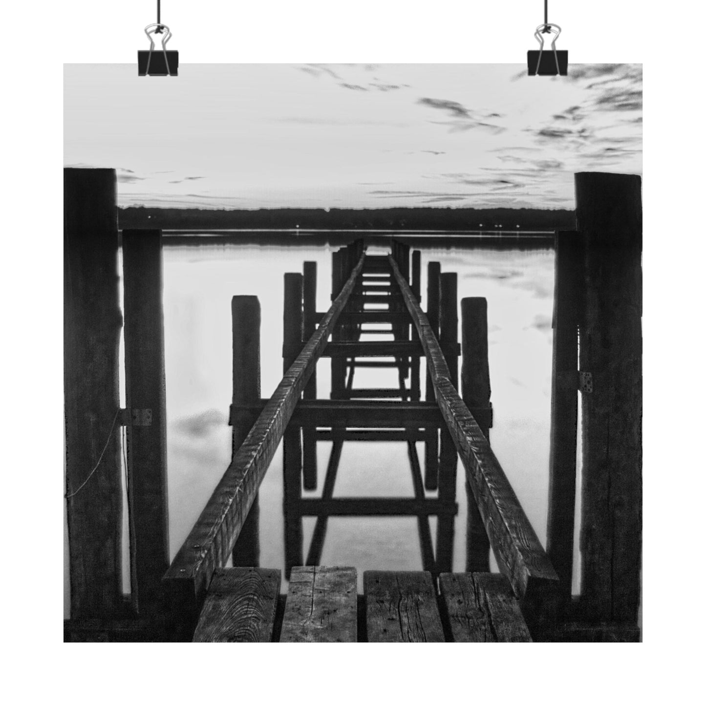 Black and white photo of a wooden pier extending into water