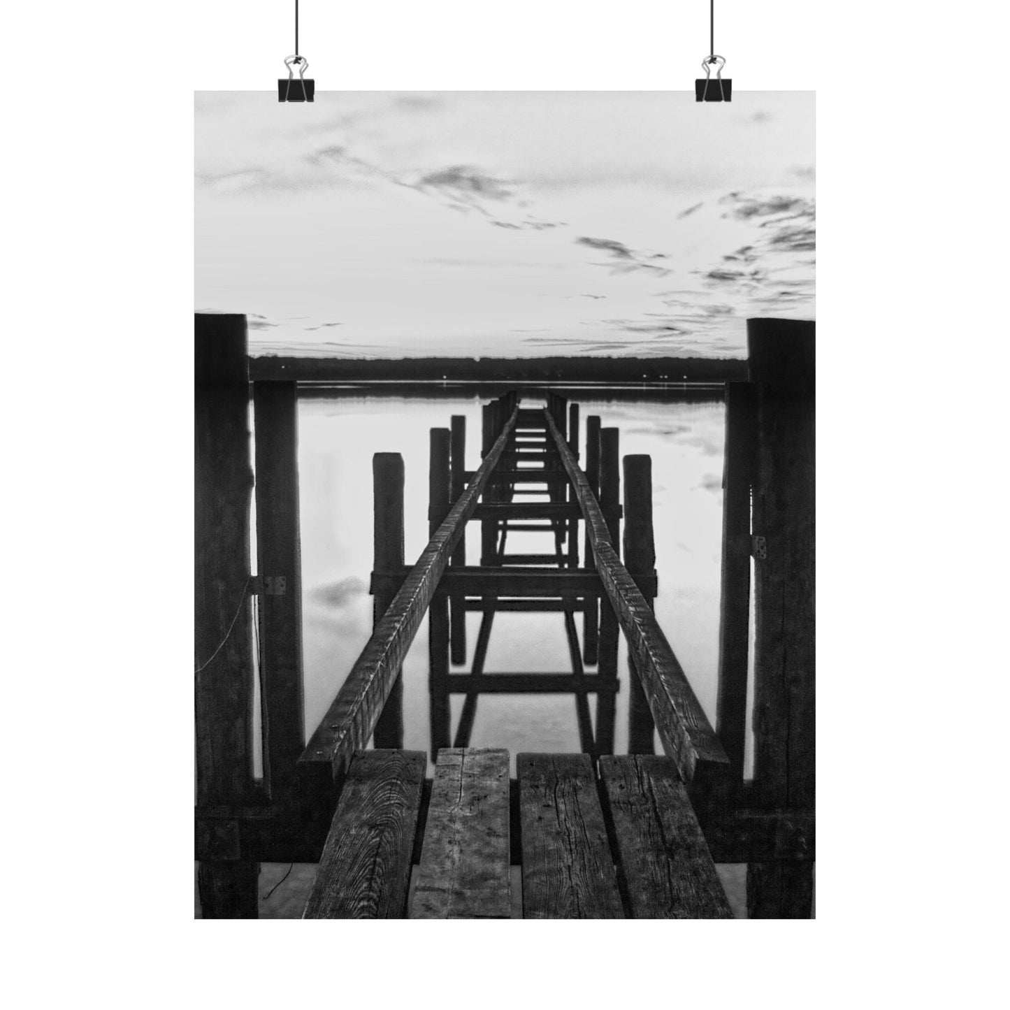Black and white photo of a wooden pier extending into water