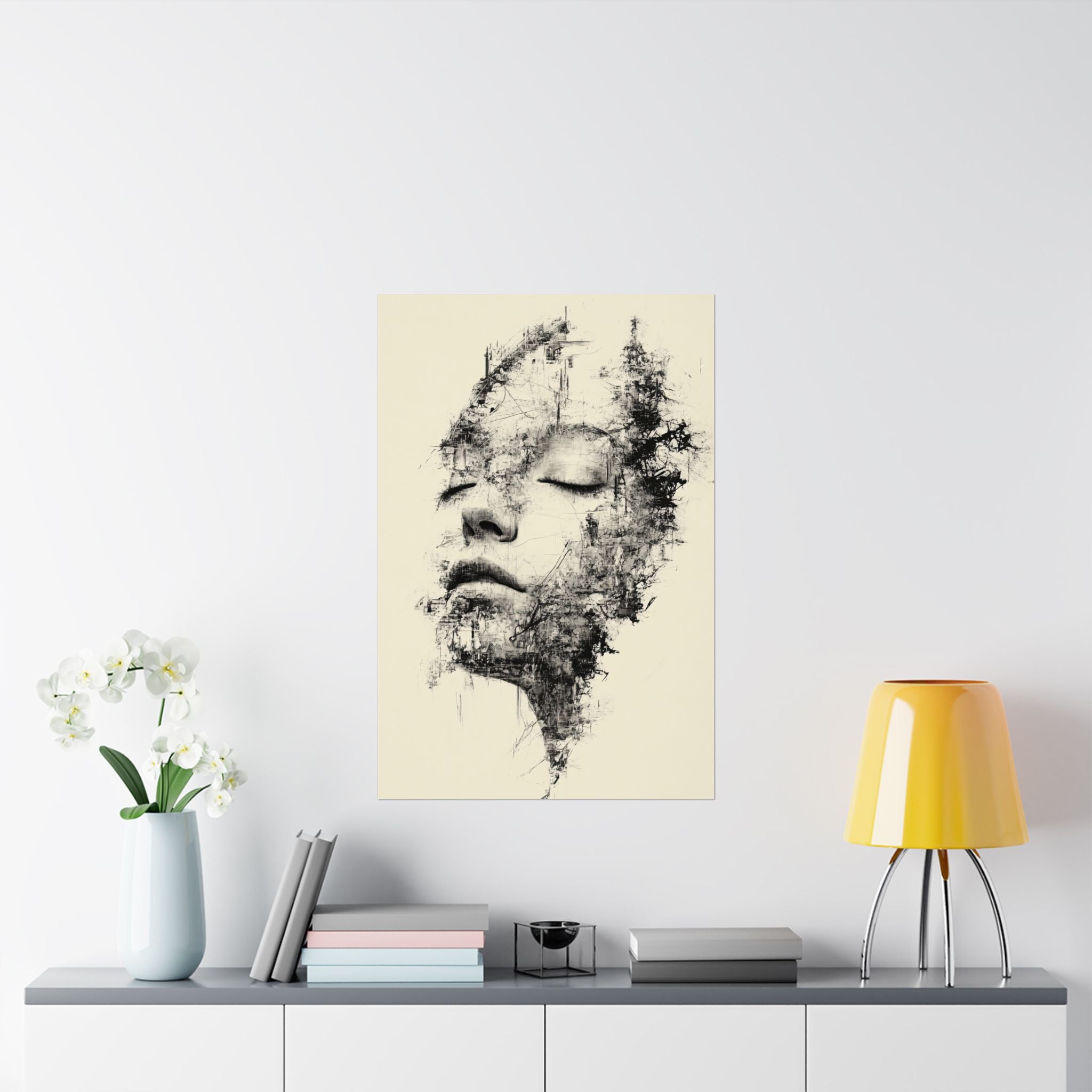 Abstract art print of a face on a wall above a table with decor items.