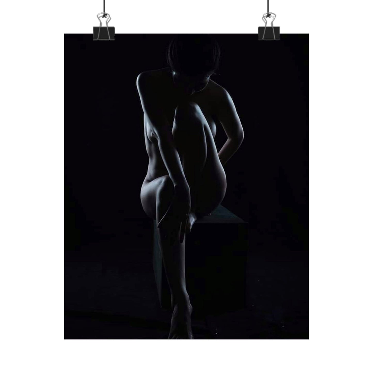 Silhouette of a nude figure against a black background