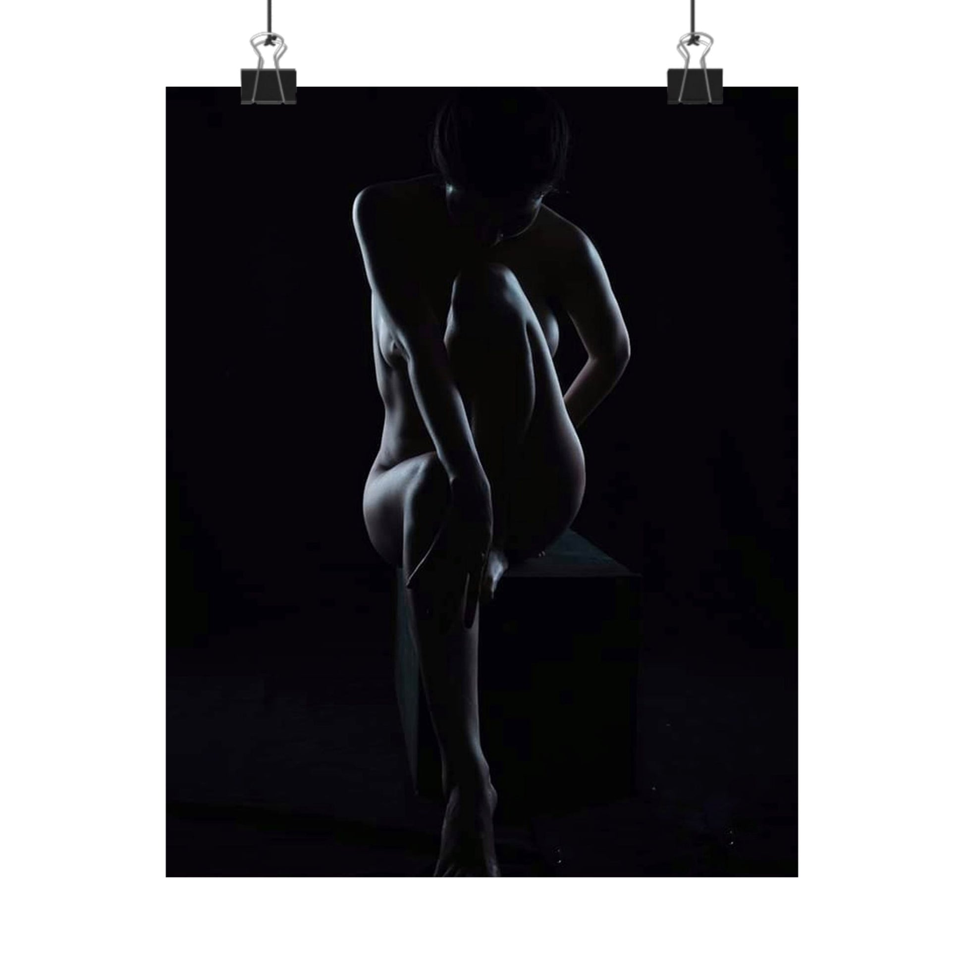 Silhouette of a nude figure against a black background