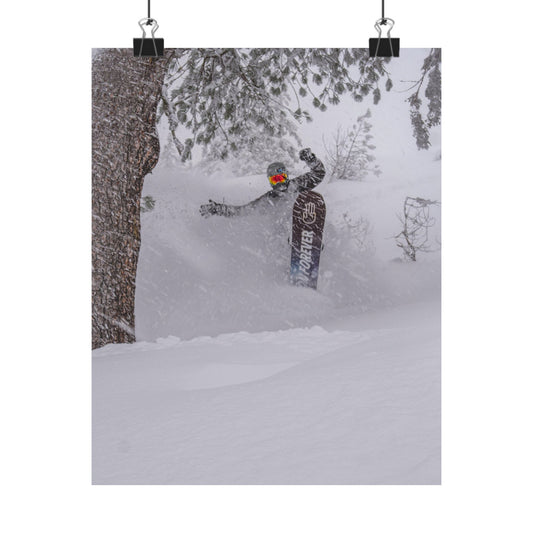Person snowboarding in a snowy forest with a snowboard visible