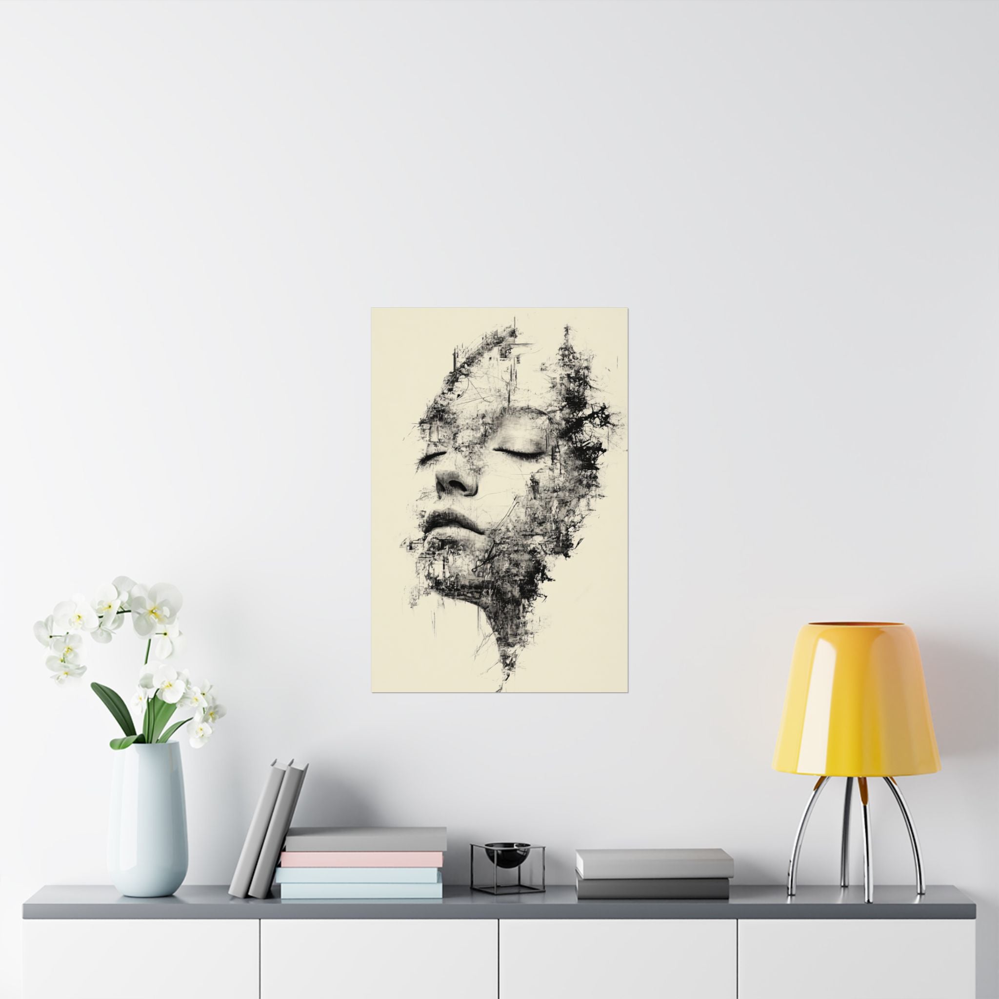 Abstract art print of a face on a wall above a table with decor items.