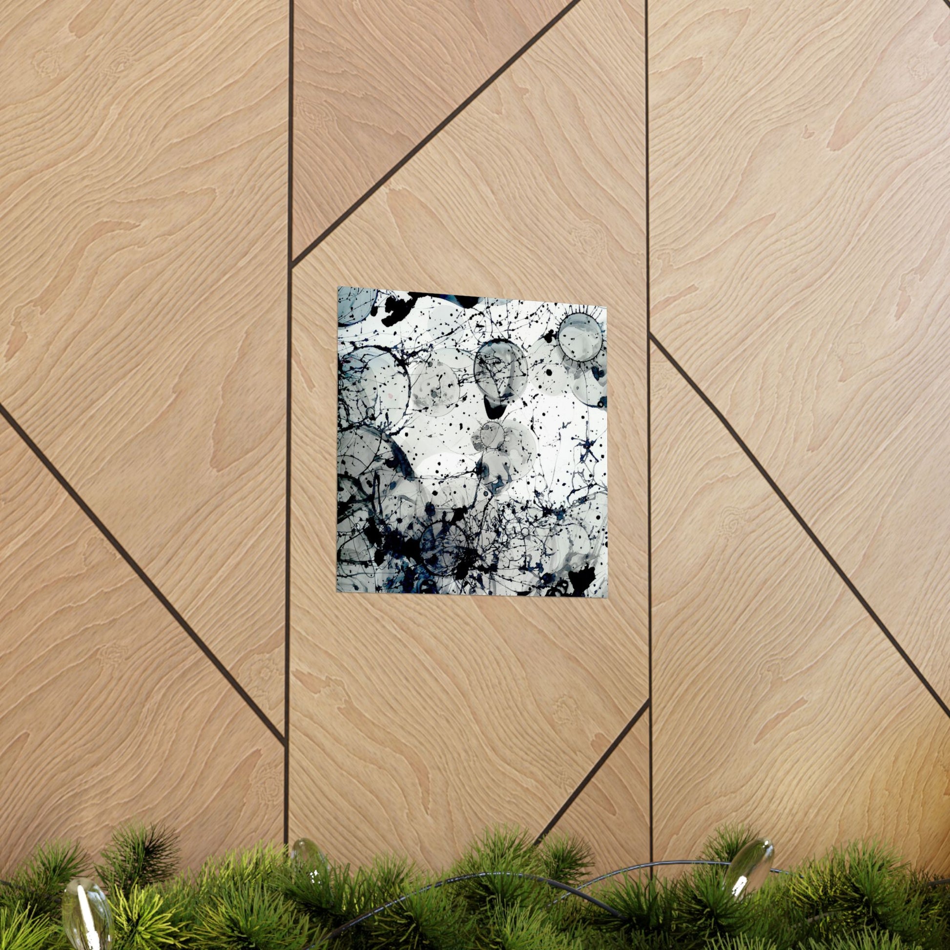 Abstract black and white pattern on a wooden surface with greenery at the bottom.