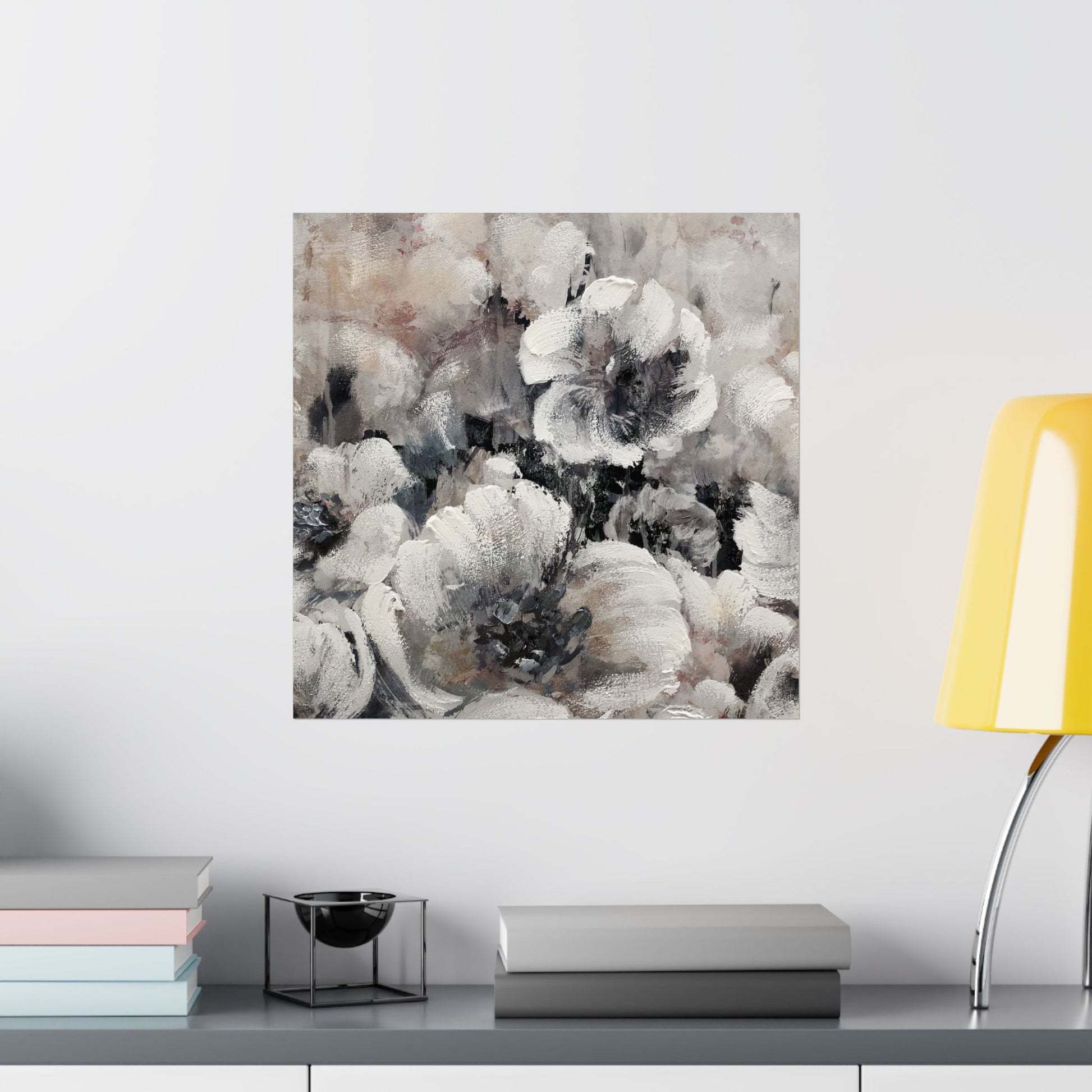 Abstract floral art print on a wall above a shelf with books and decor items.