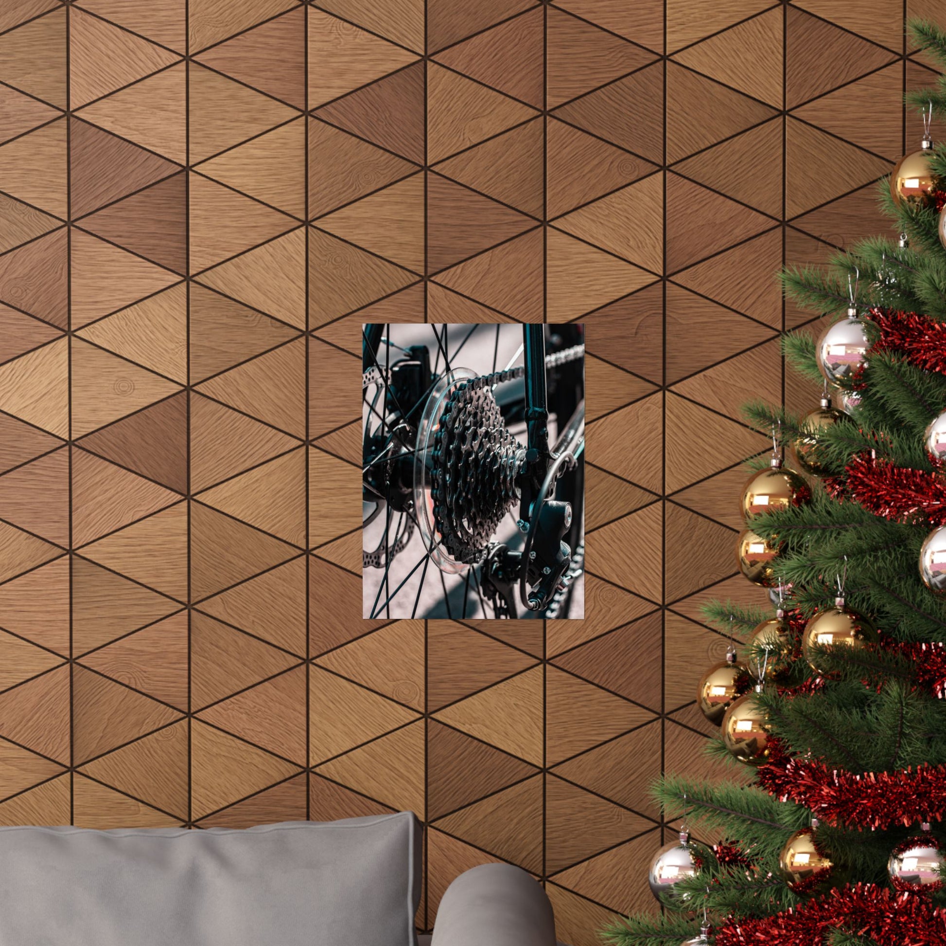 Wooden wall with geometric pattern, framed picture, and Christmas tree with decorations.