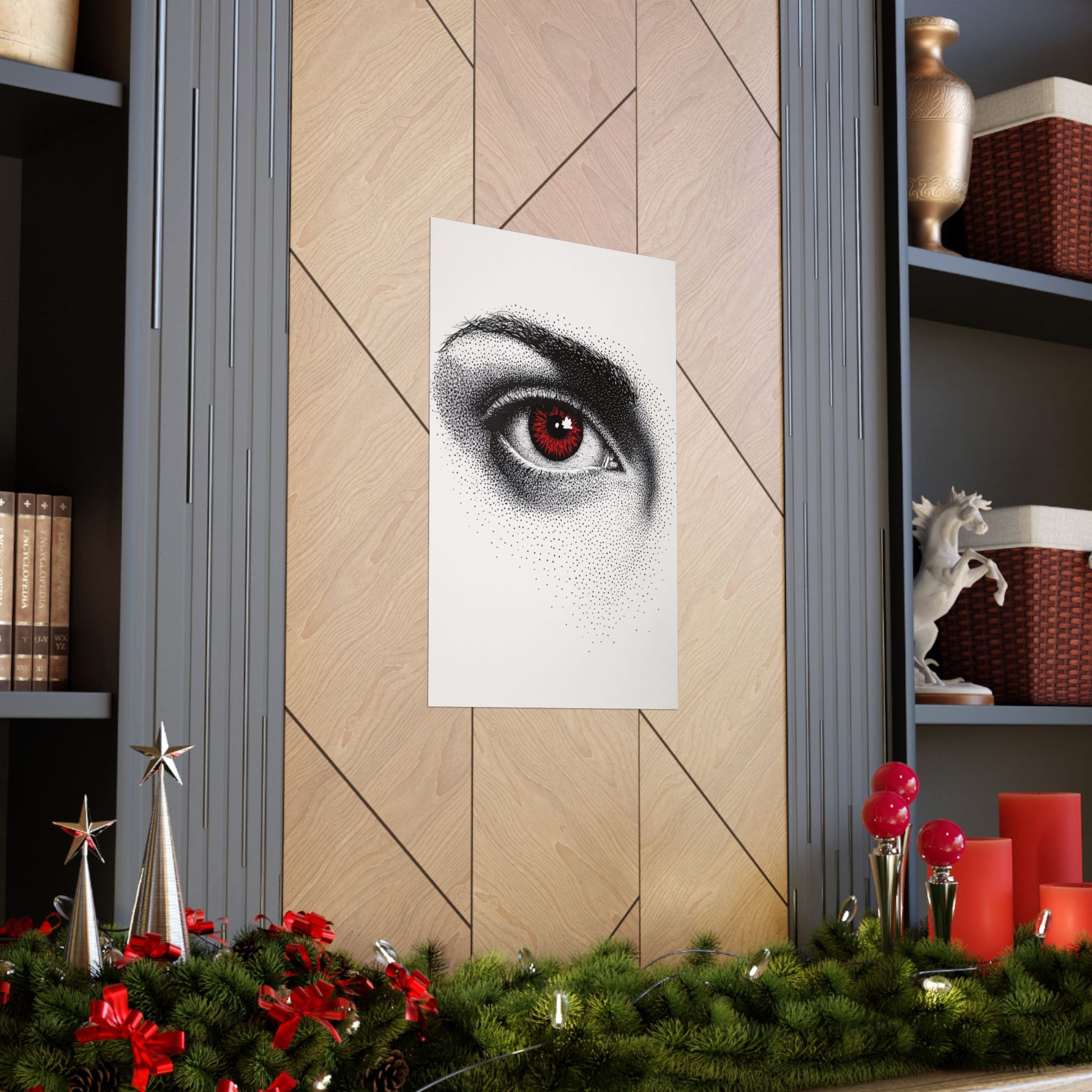 Decorative wall art of a red-eyed eye on a wooden wall with Christmas decorations below.