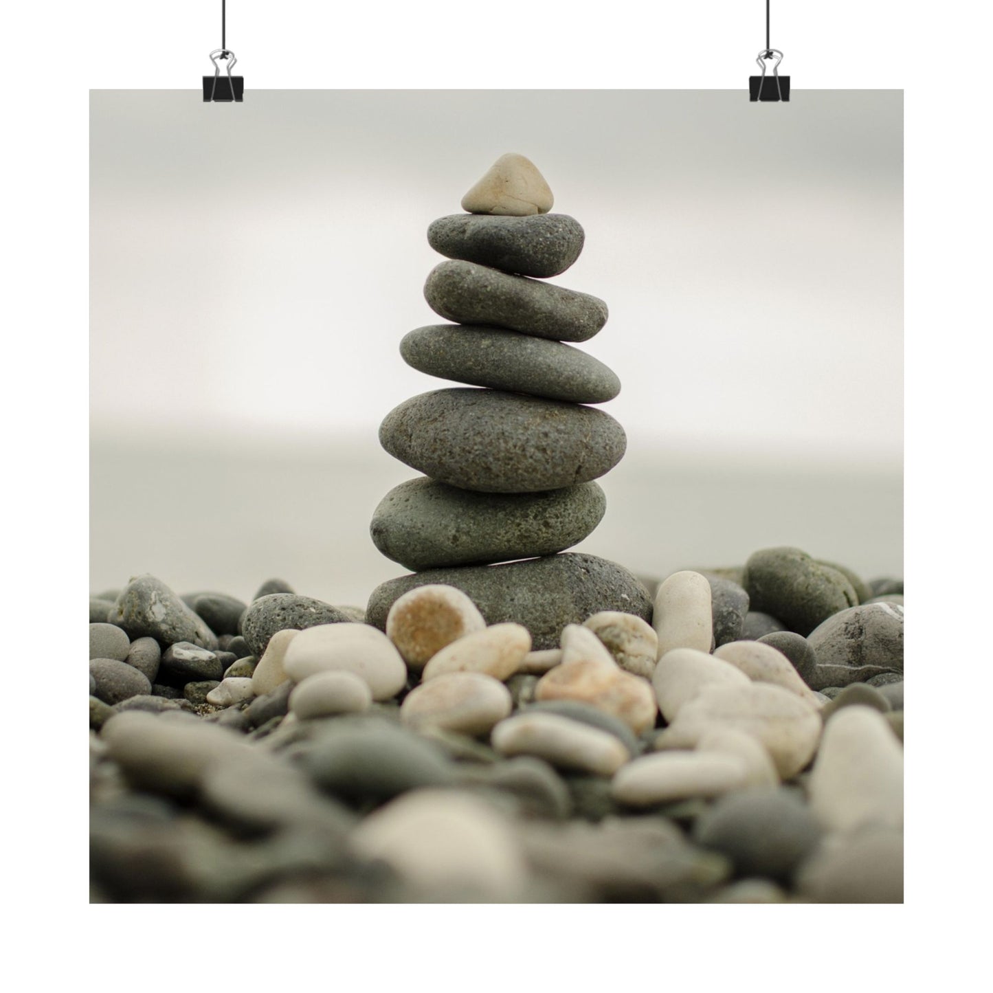 Stack of stones on a beach with a light background