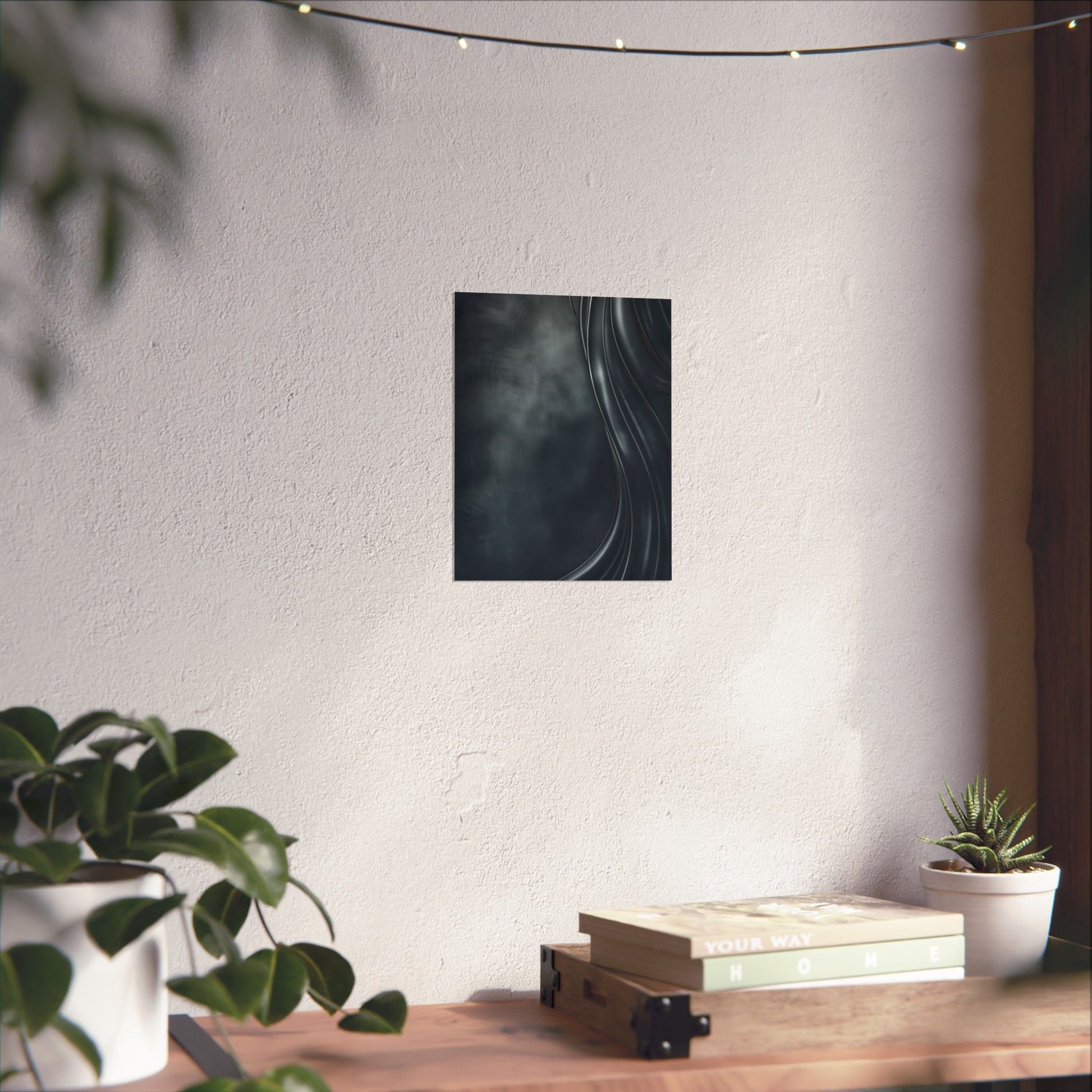 Poster of a circular design on a wall above a wooden shelf with books and plants.