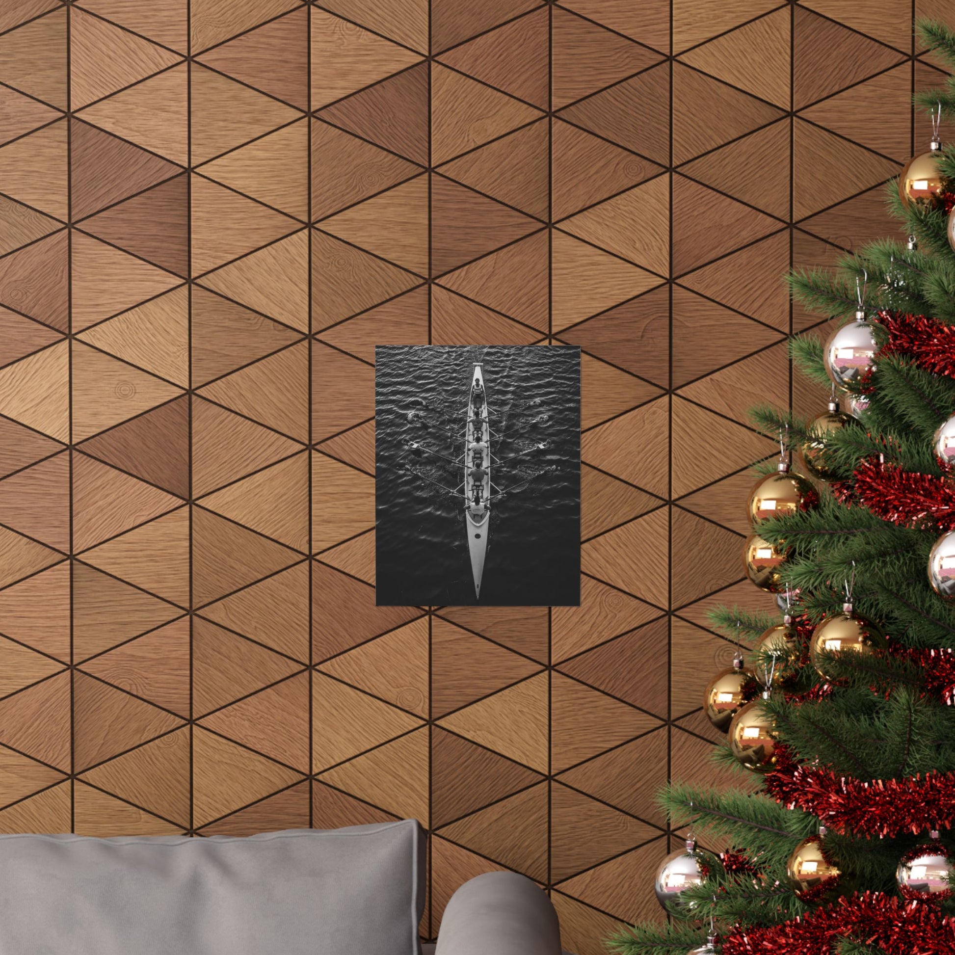 Wooden wall with geometric pattern, framed picture, and Christmas tree with decorations.