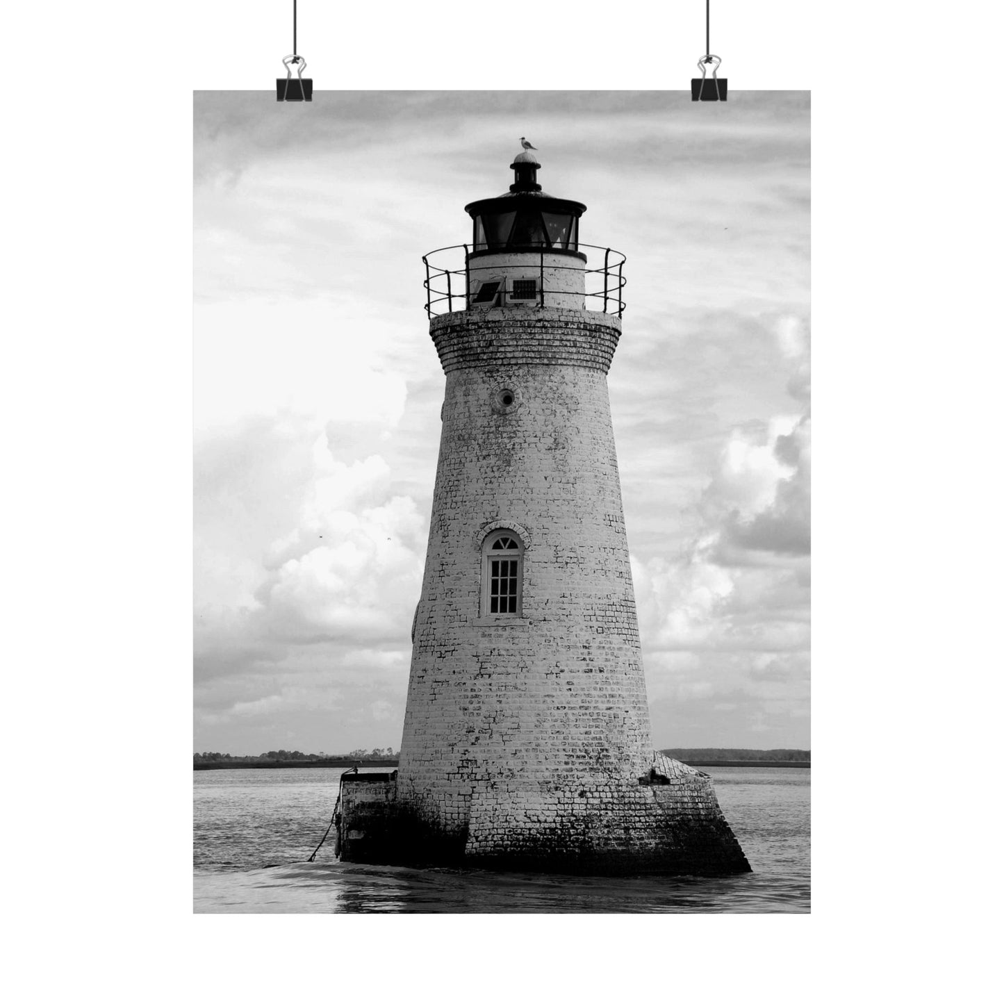 Black and white lighthouse poster hanging on a white background