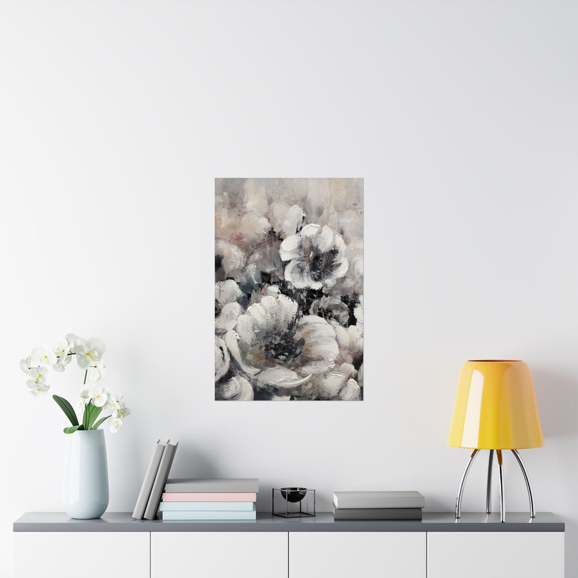 Framed floral art piece on a wall above a table with decor items.