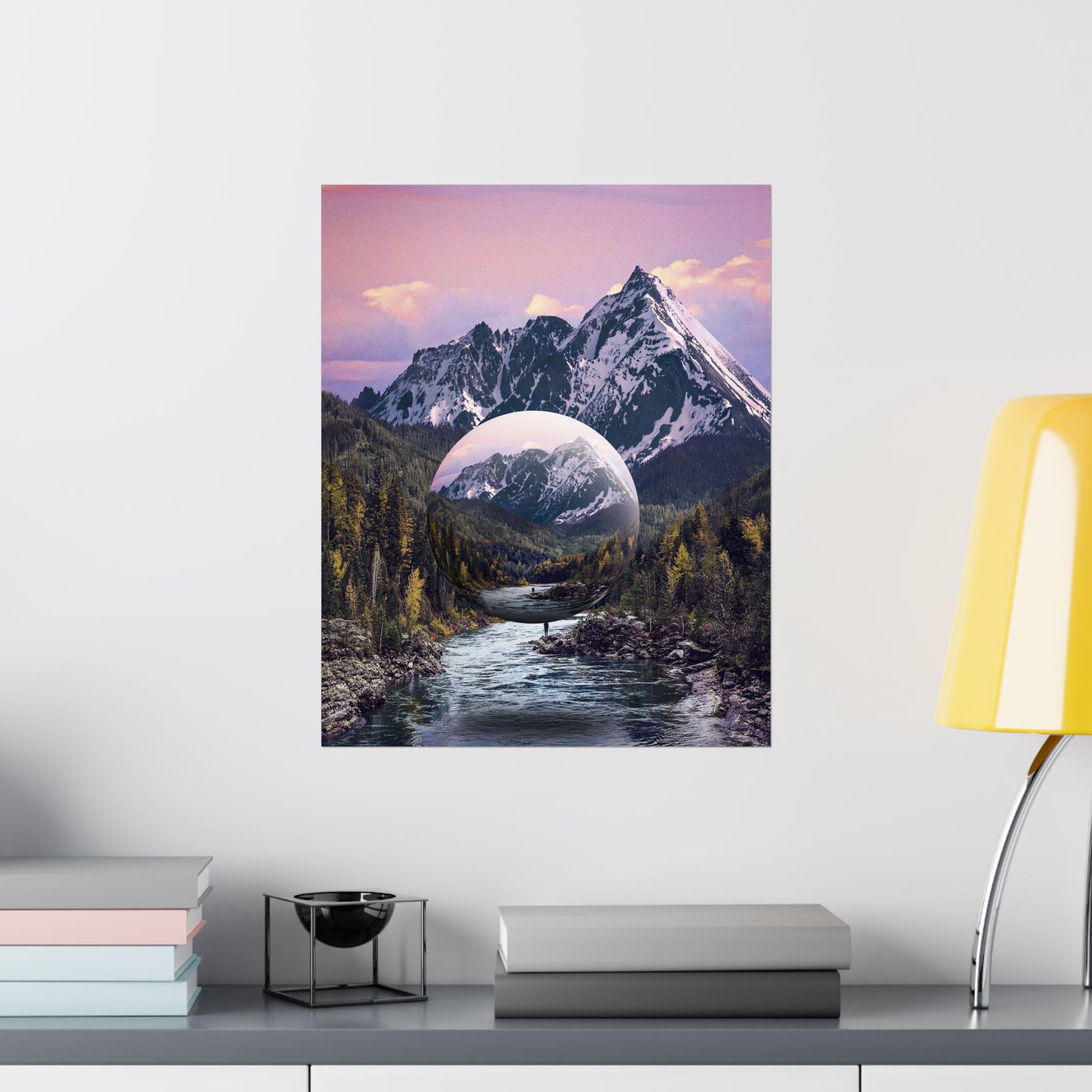 Framed artwork of a mountain landscape with a reflective lake on a white wall.