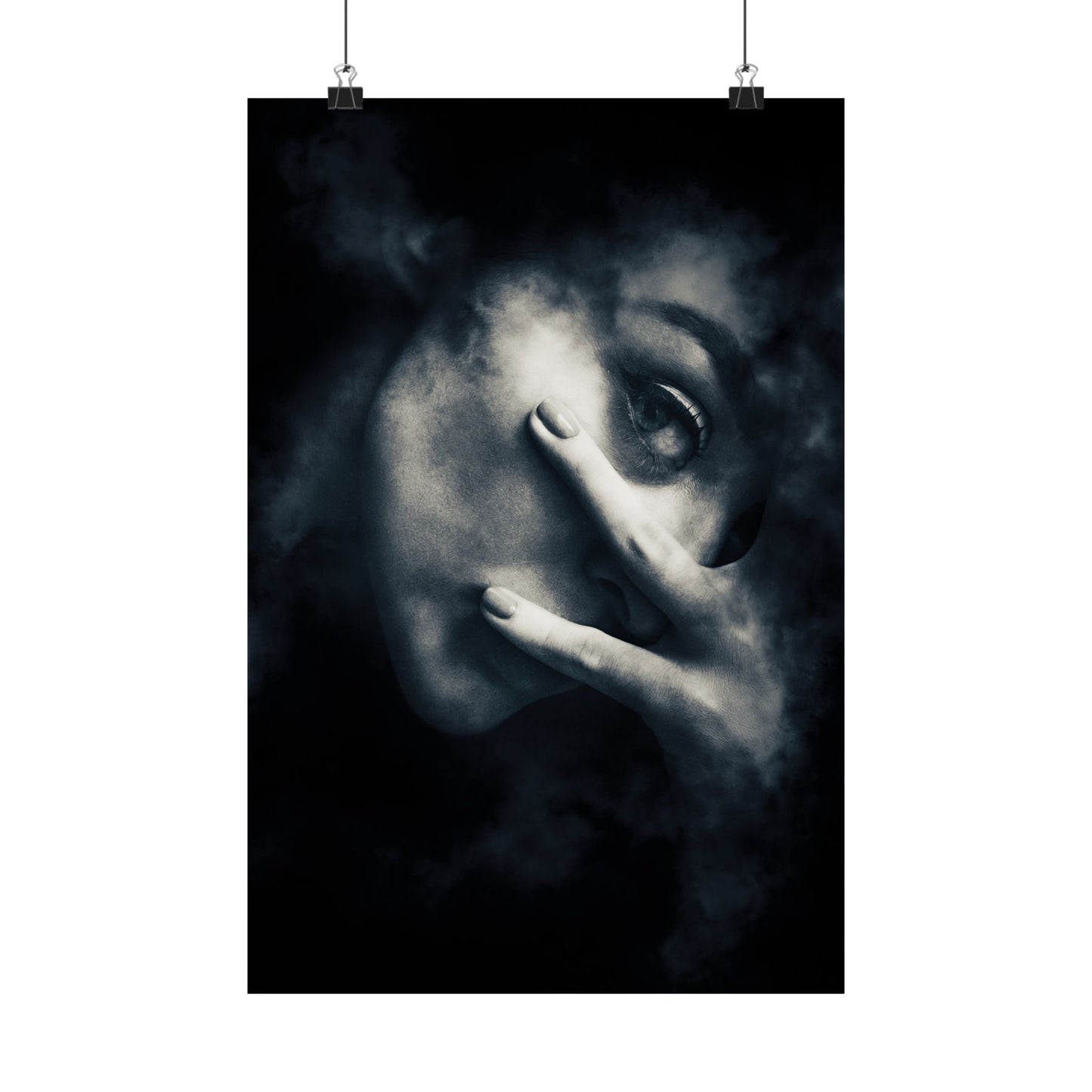 Black and white artwork of a face with a hand covering one eye, hanging on a white wall.