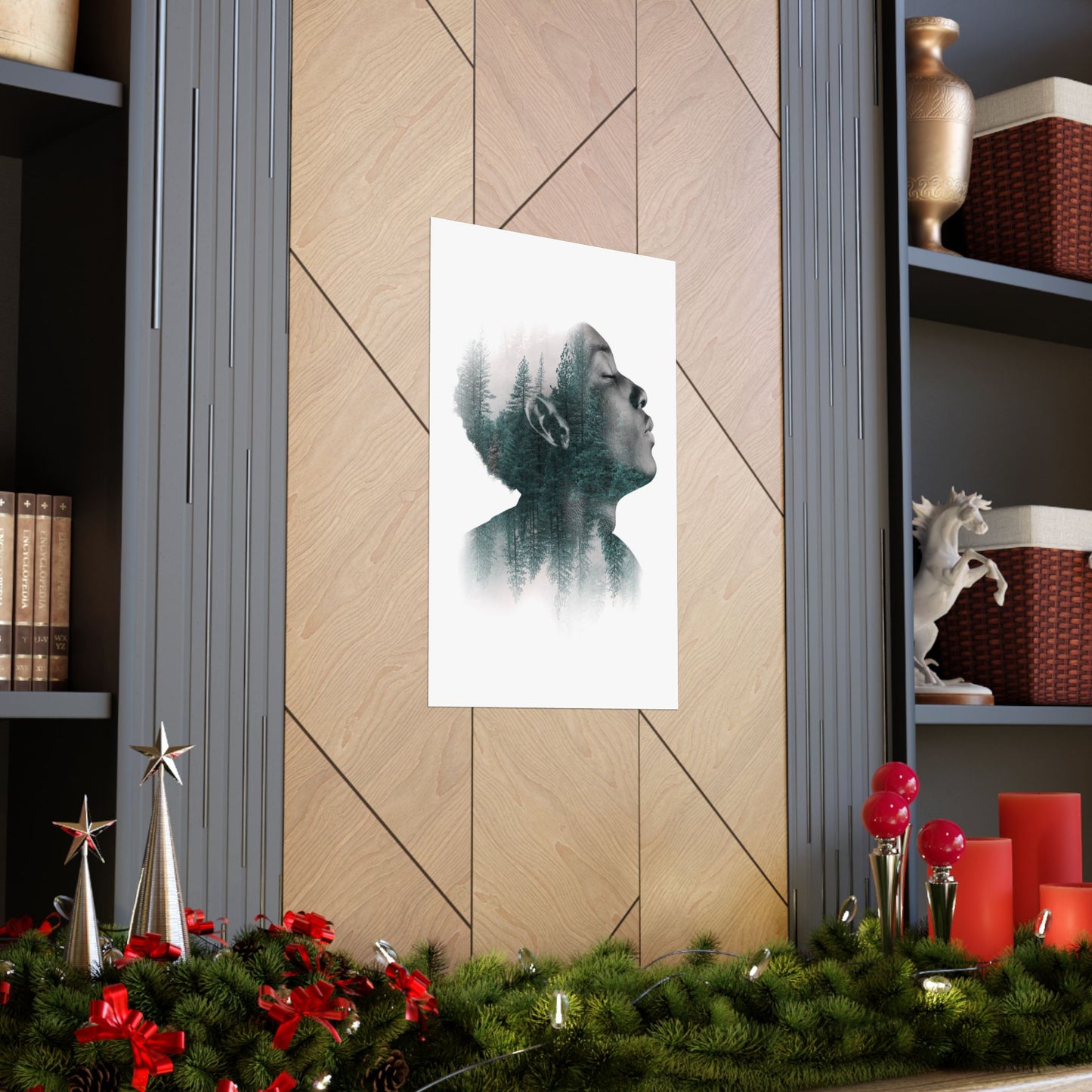 Framed artwork of a silhouette against a white background on a wooden wall, with festive decorations at the bottom.