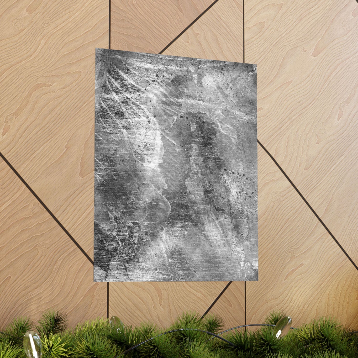 Textured gray paper on a wooden surface with greenery at the bottom