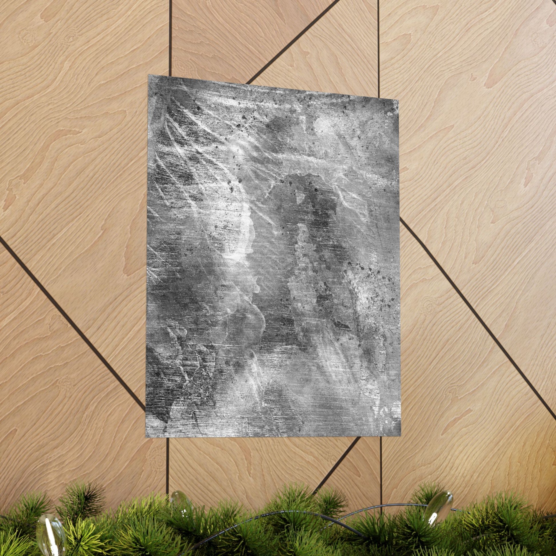 Textured gray paper on a wooden surface with greenery at the bottom