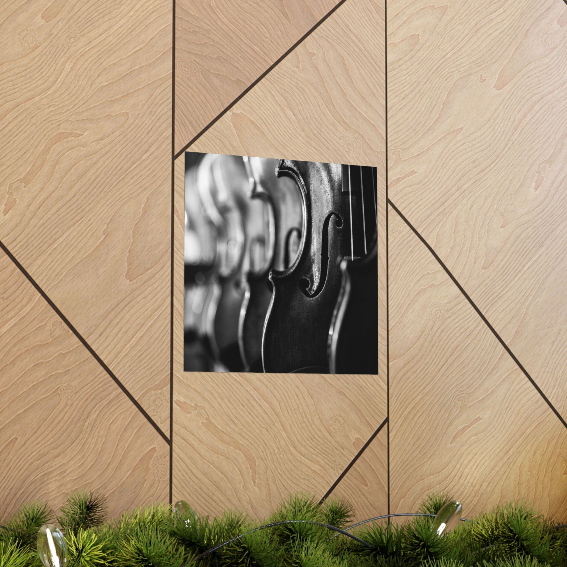 Framed black and white photo of a violin on a wooden wall with geometric patterns.
