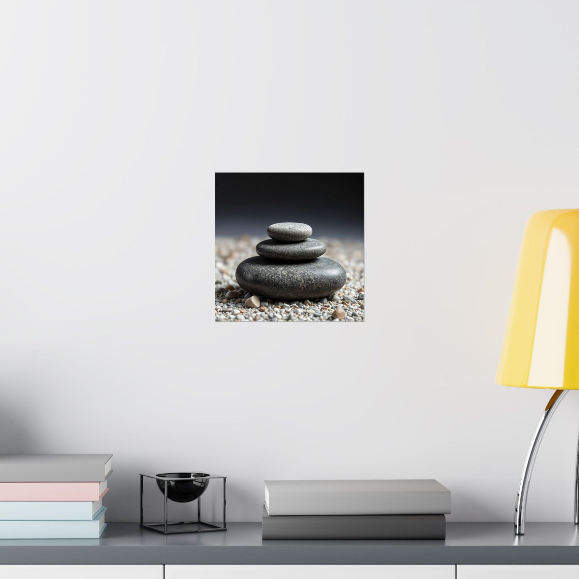 Stylized image of stacked stones on a pebble bed with a minimal background, displayed on a wall above a shelf.