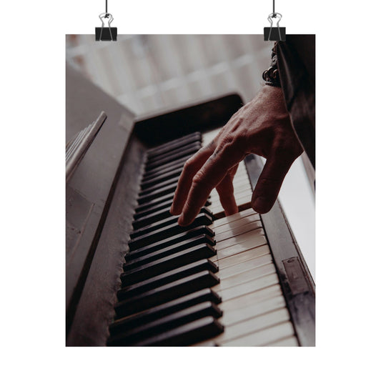 Hand playing a piano with a blurred background