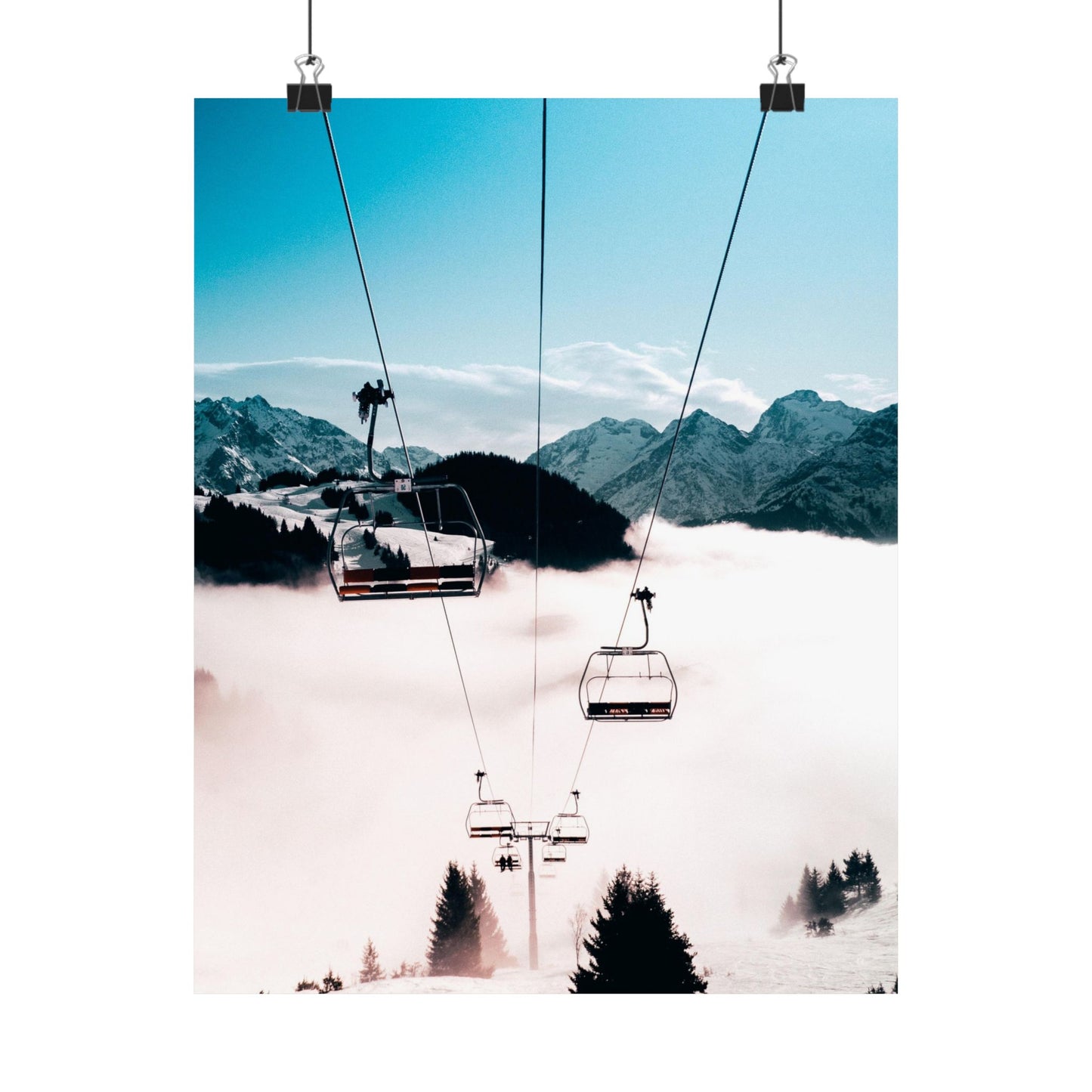 Ski lift with mountains and clouds in the background