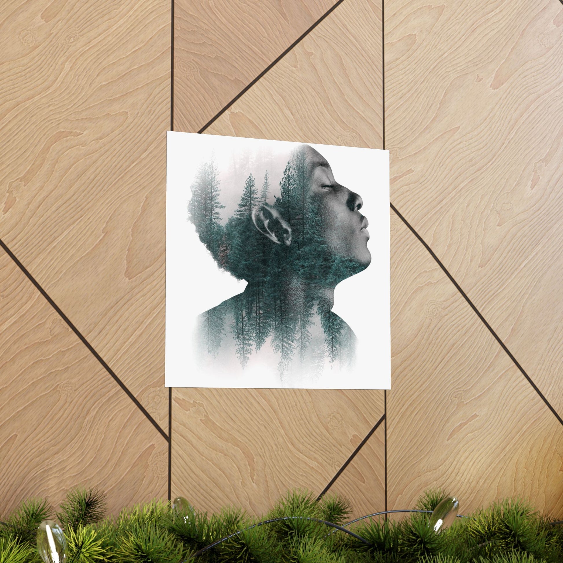 Art print of a person with nature融合在他们的脸上的设计，放在木制表面上。