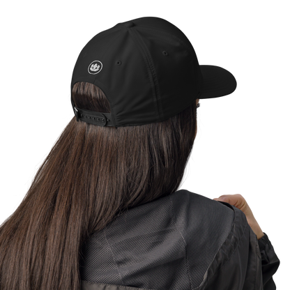 Person wearing a black cap and jacket on a white background
