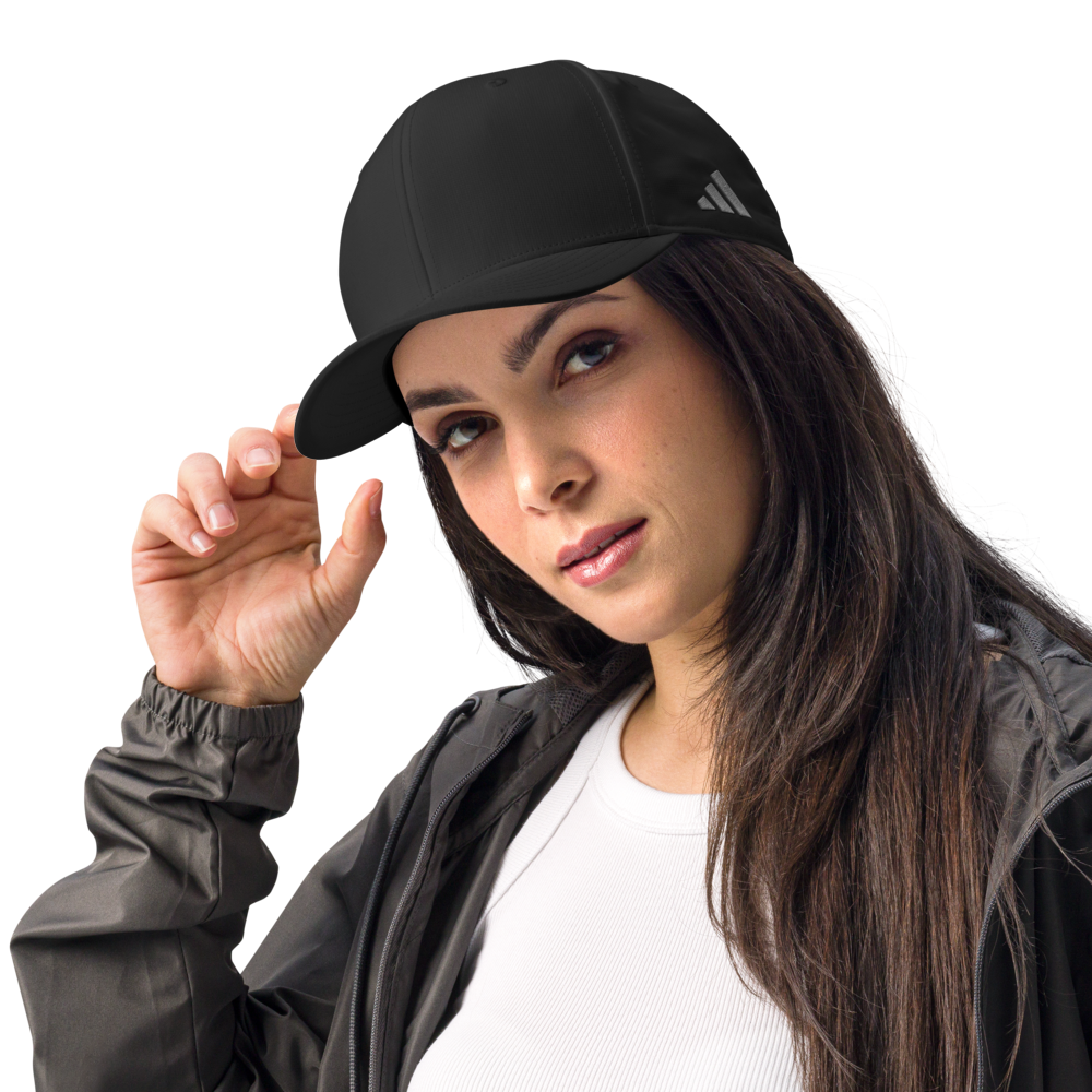 Woman wearing a black Adidas cap on a white background