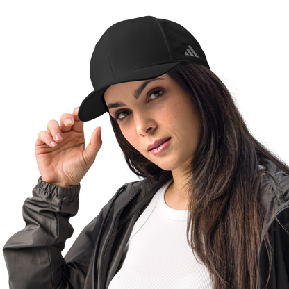 Woman wearing a black Adidas cap on a white background