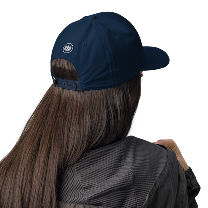 Person wearing a navy blue cap with a logo on a white background