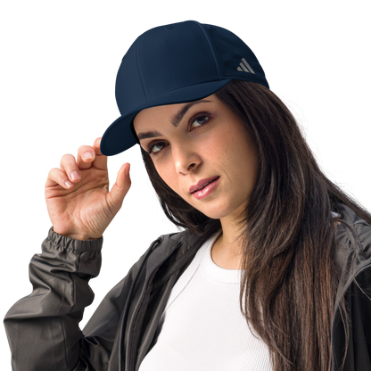 Woman wearing a navy blue Adidas cap on a white background