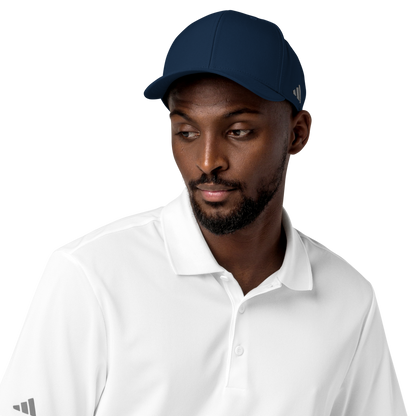 Man wearing a navy cap and white shirt with Adidas logo on a white background