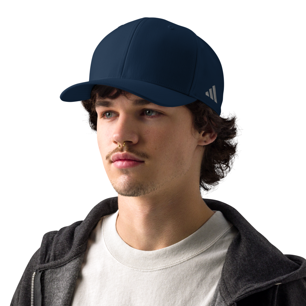 Man wearing a navy blue Adidas cap on a white background