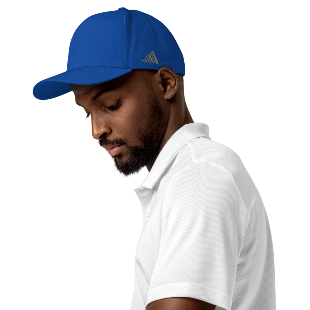 Man wearing a blue Adidas cap and white polo shirt on a white background