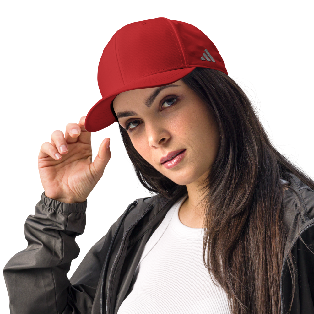 Woman wearing a red Adidas cap on a white background