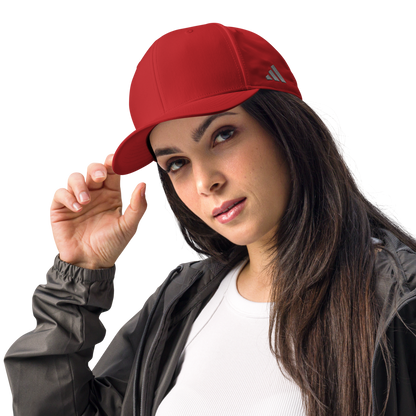 Woman wearing a red Adidas cap on a white background