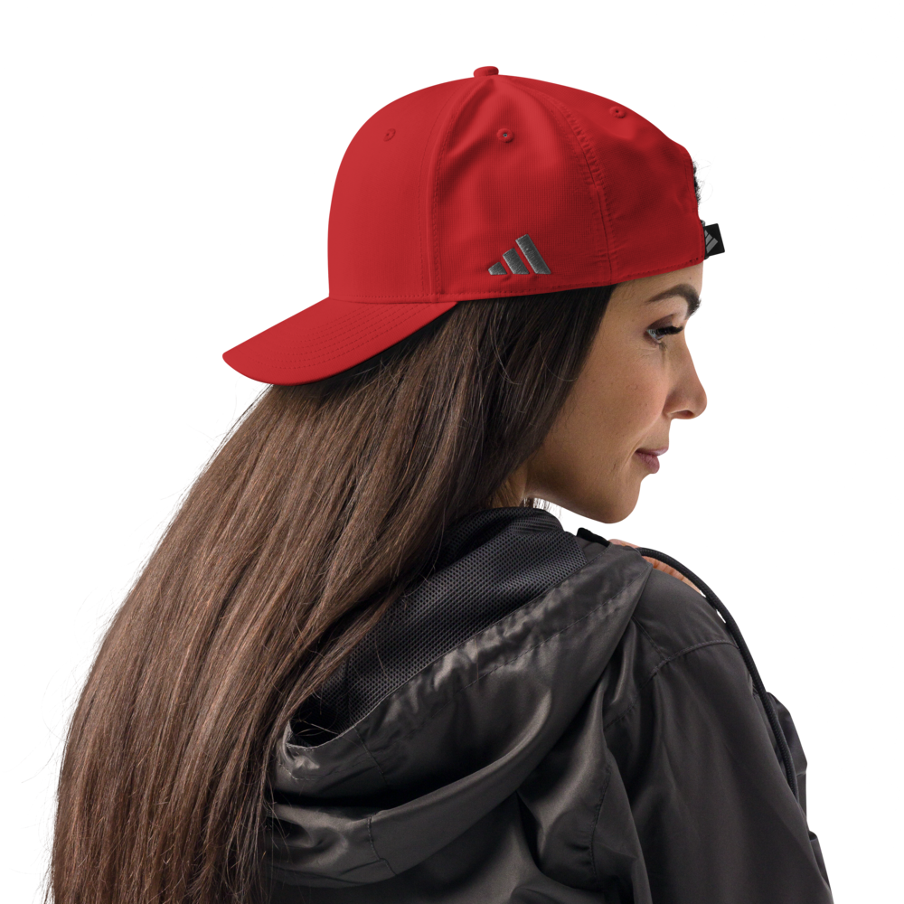 Woman wearing a red Adidas cap on a white background