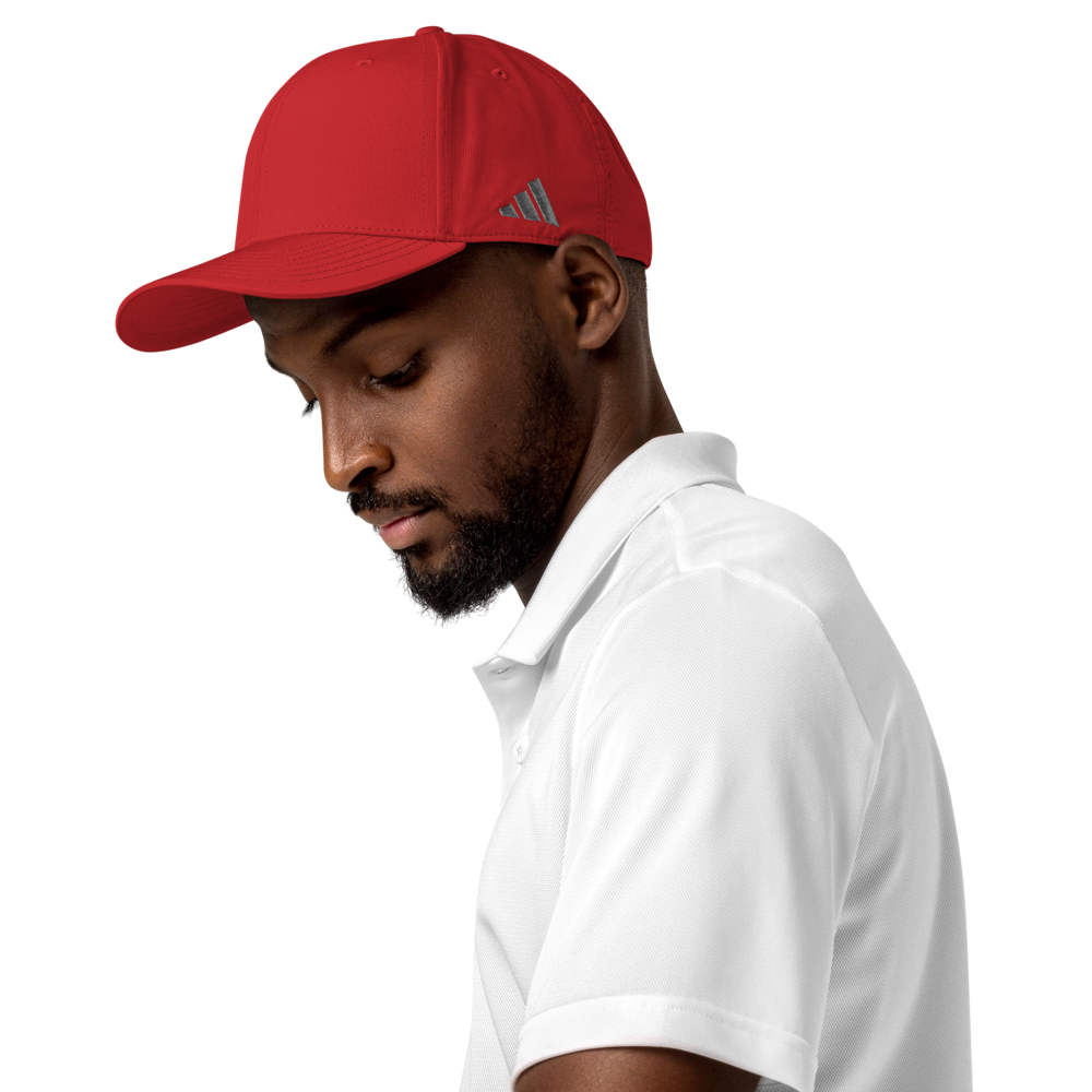 Man wearing a red cap with an Adidas logo on a white background