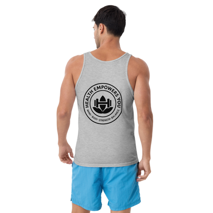 Man wearing a gray tank top with a logo and blue shorts on a white background