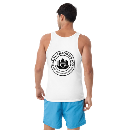 Man wearing a white tank top with a black logo and blue shorts on a white background